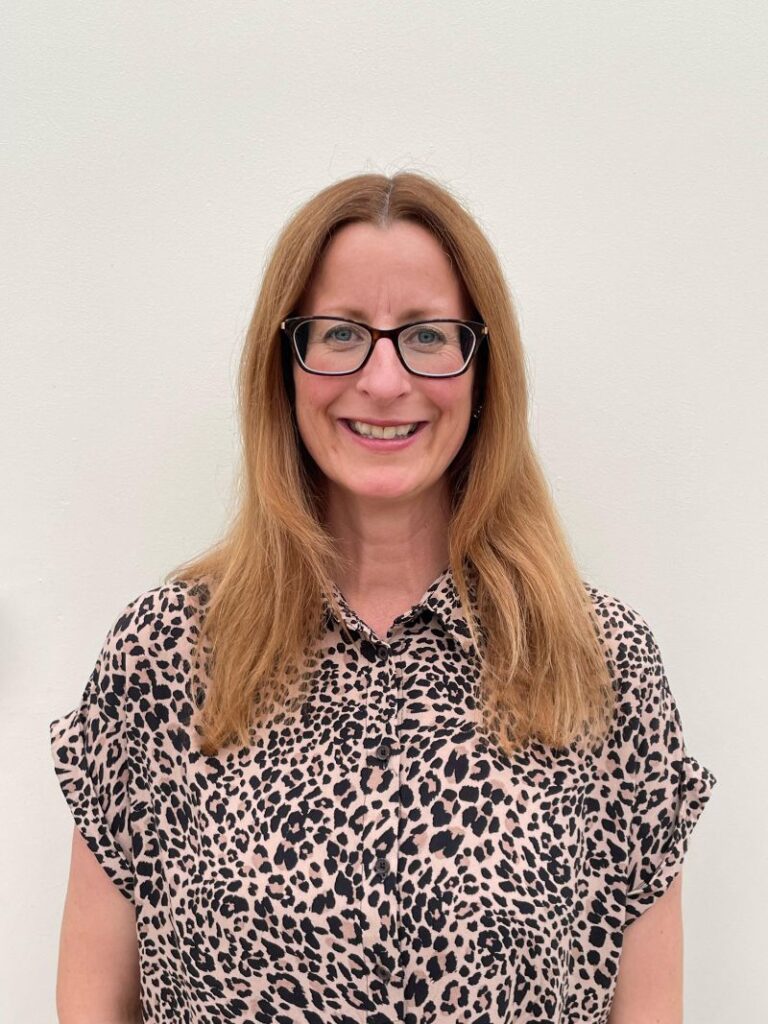 Person with long hair, animal print shirt.